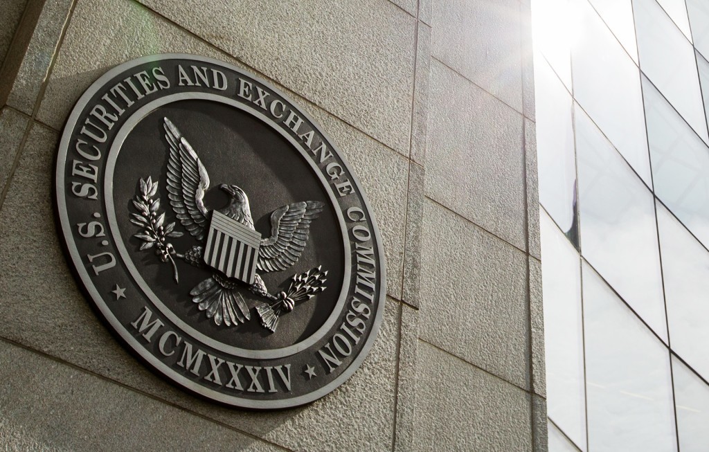 FILE - This June 19, 2015 file photo shows the seal of the U.S. Securities and Exchange Commission at SEC headquarters, in Washington. The Securities and Exchange Commission on Wednesday, Aug. 5, 2015 voted to order most public companies to disclose the ratio between their chief executives' annual compensation and median, or midpoint, employee pay. The new rule will take effect starting in 2017. (AP Photo/Andrew Harnik, File)